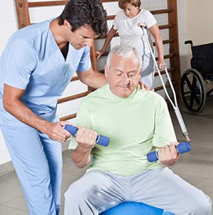 An elderly man training with his physical therapist
